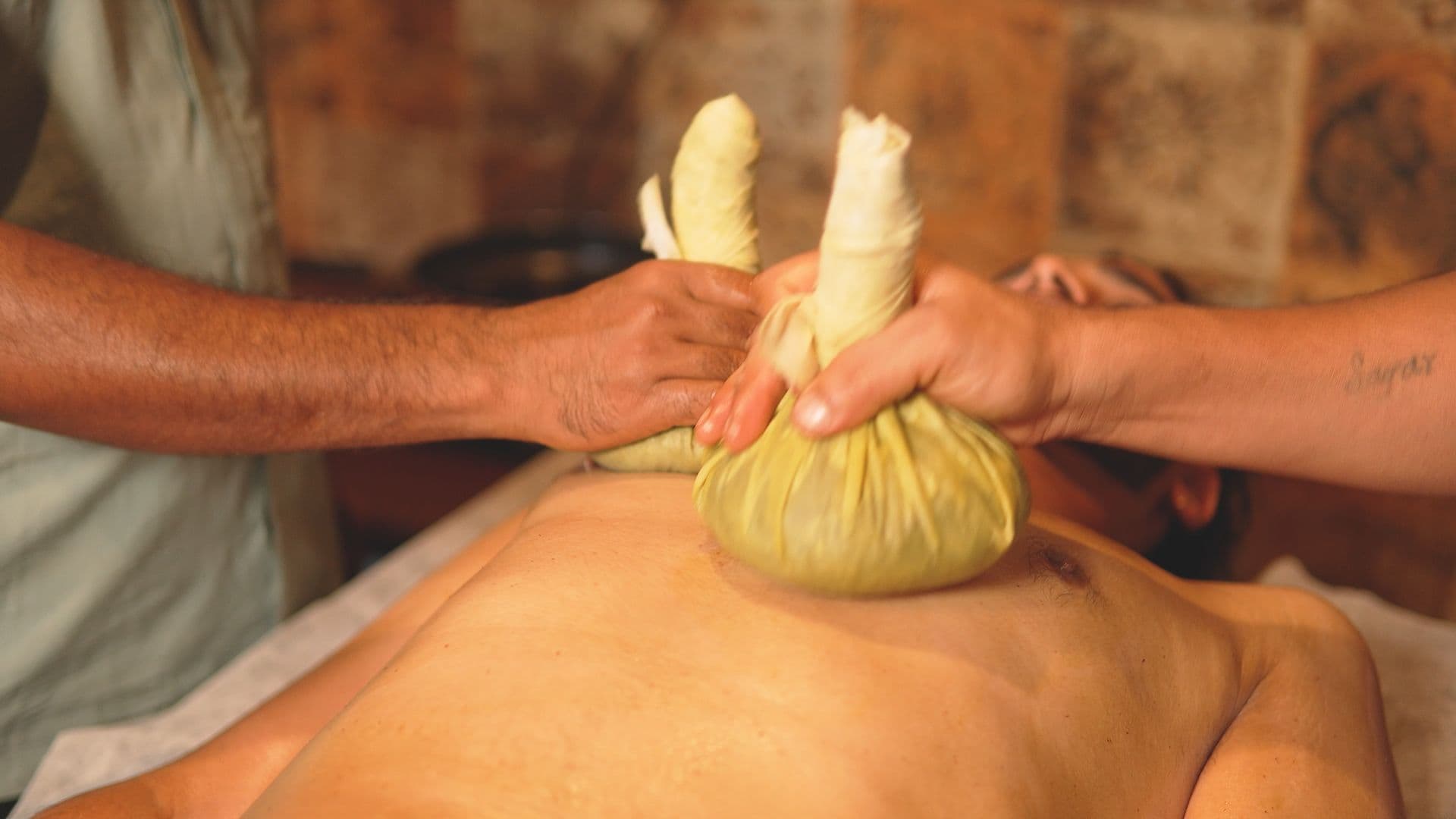 Potli (herbal bolus) massage in an Ayurveda therapy room